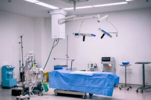 A hospital room filled with various medical equipment, including surgical instruments and monitoring machines.