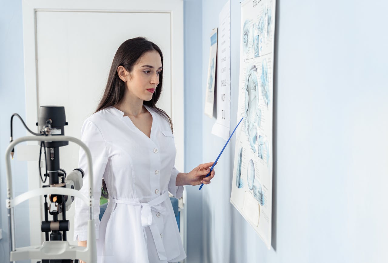 Ophthalmologist explaining eye anatomy and vision care to a patient at a Malaysian eye clinic.