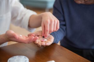 Palliative care social worker supports medication routine to ensure patient comfort and dignity