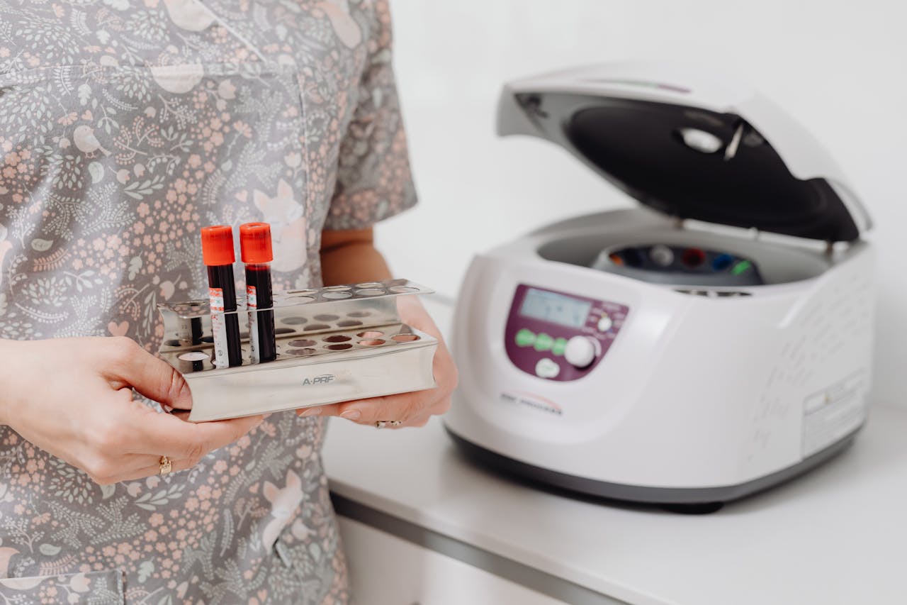 Blood samples prepared by a pathologist for analysis using a centrifuge in a medical lab