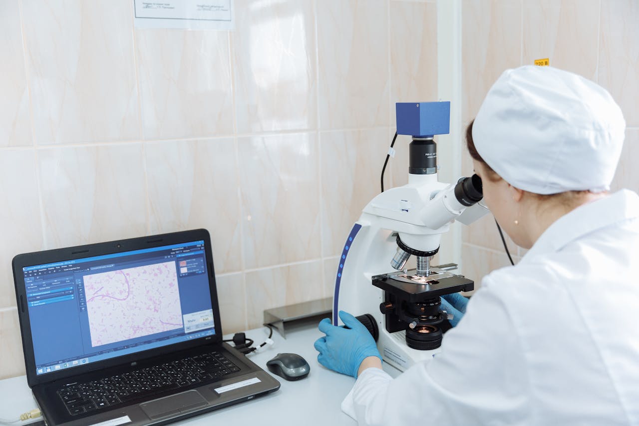 Pathologist uses microscope to examine tissue sample for diagnosis in a medical lab