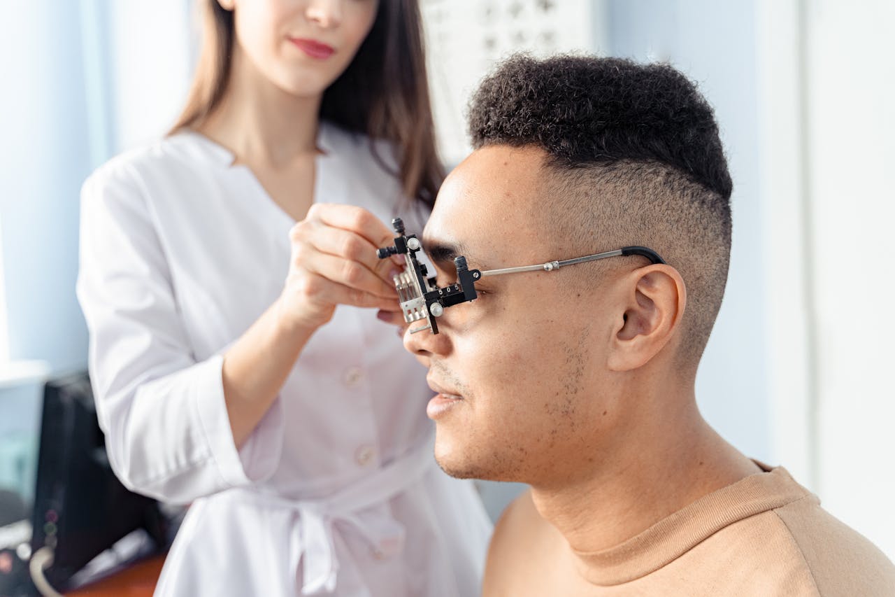 Ophthalmologist adjusting optometry test lenses during an eye examination