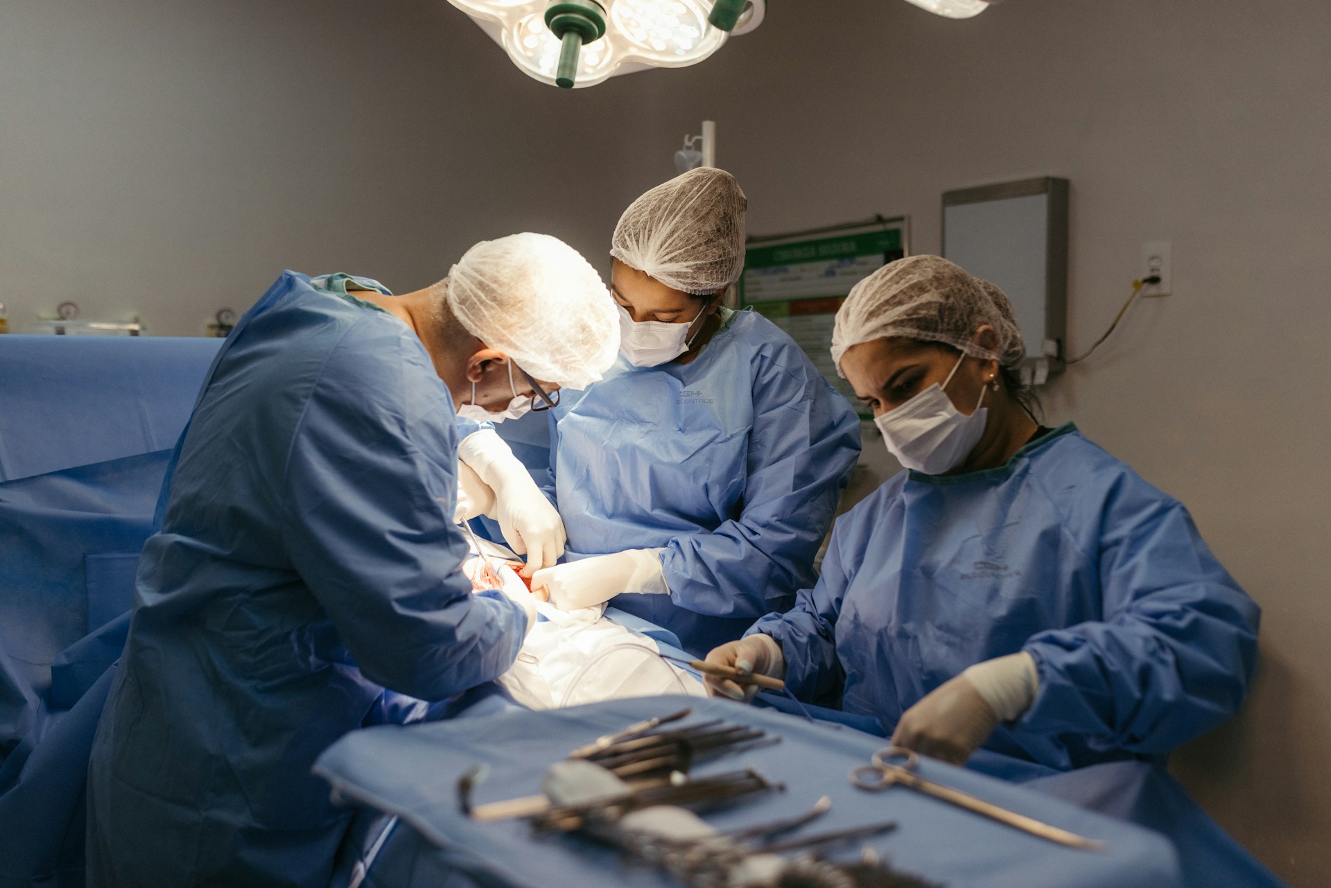 Public health surgeons performing surgery in a hospital operating room.